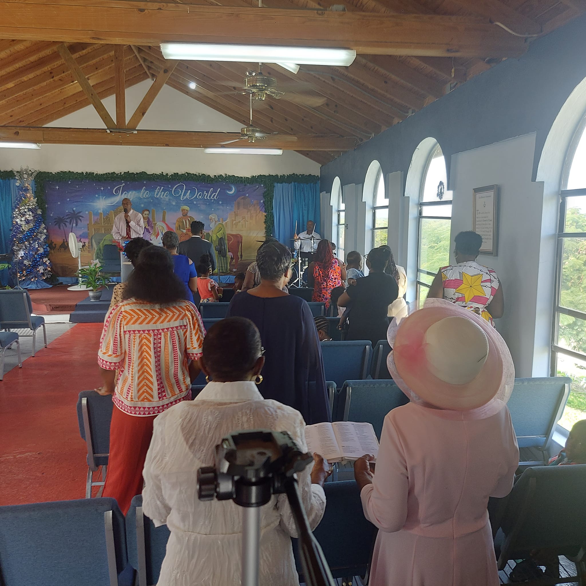 Congregation standing in worship during a Sunday service at the chapel